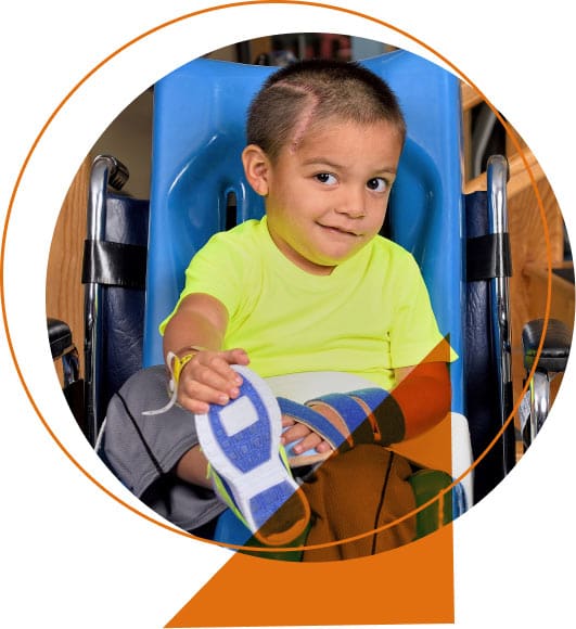 Young boy in wheelchair after brain injury