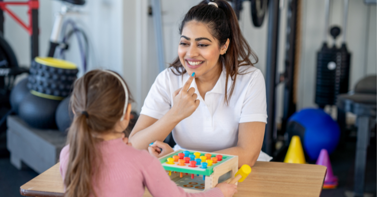 Young girl playing game with a therapist
